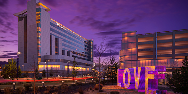 front of Renown Health building at night with LOVE sculpture